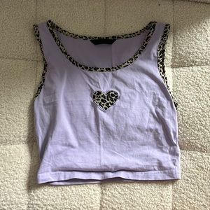 selling a purple patterned tank with a heart on the front.